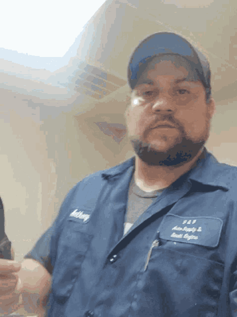 a man wearing a blue shirt that says anthony