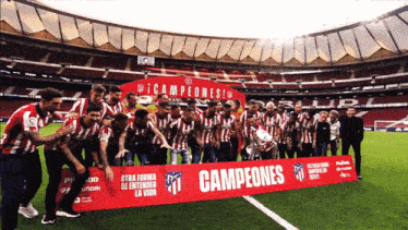 a group of soccer players are holding a banner that says campeones