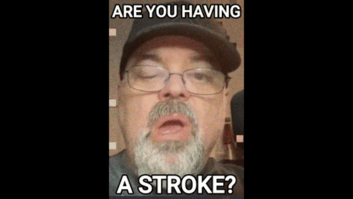 a man with a beard wearing glasses and a hat says are you having a stroke