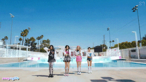 a group of girls are standing in front of a swimming pool and the word ncsoagifs is on the bottom right