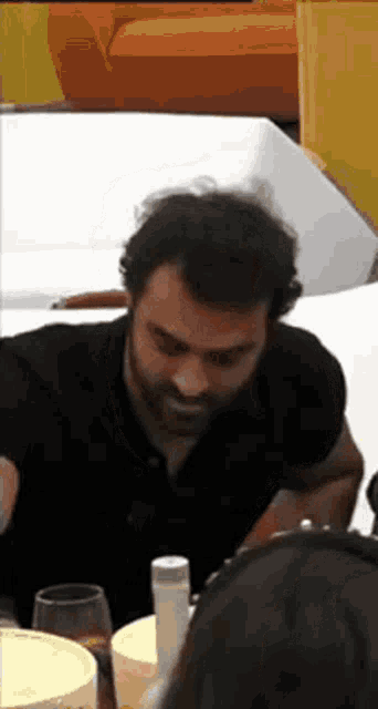 a man with a beard is sitting at a table with a woman