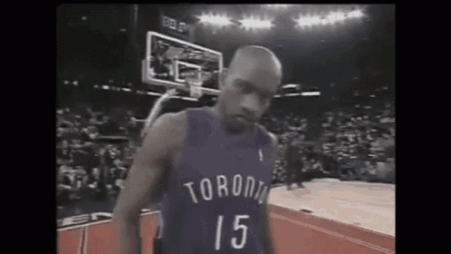 a basketball player wearing a toronto jersey is standing on a basketball court .