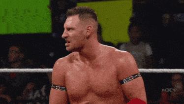 a man in a wrestling ring with the word nxt on the bottom