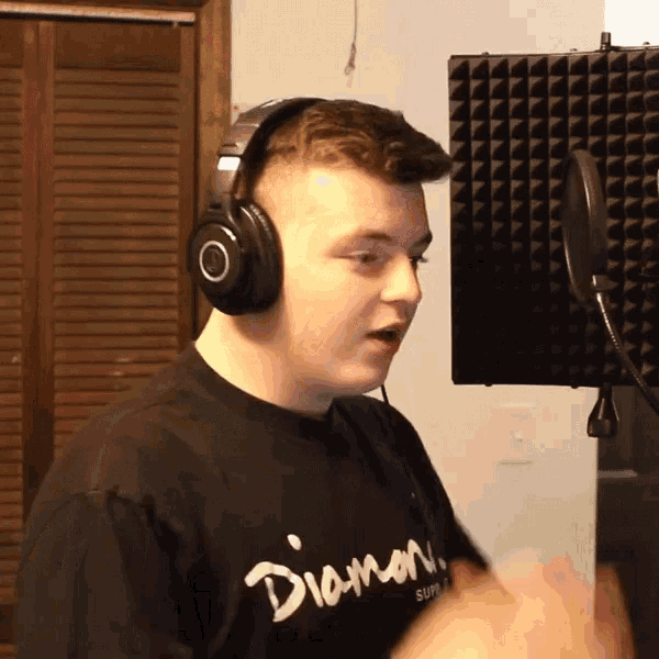 a man wearing headphones and a black shirt with the word diamond on it