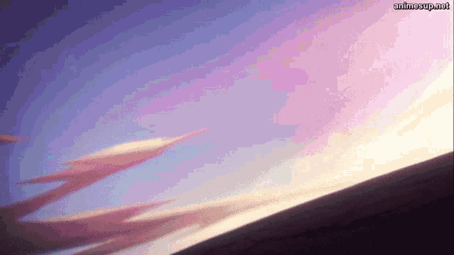 a purple and pink sky with a few clouds and a sunset in the background