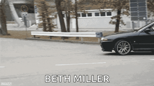 a black car is driving down a street with the name beth miller on the bottom