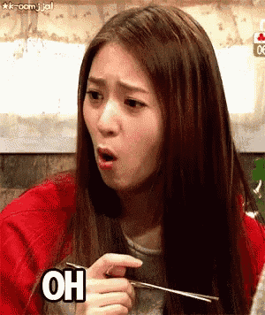 a woman is eating with chopsticks and making a funny face with the word oh above her .