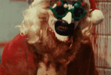 a close up of a clown wearing a santa hat and sunglasses