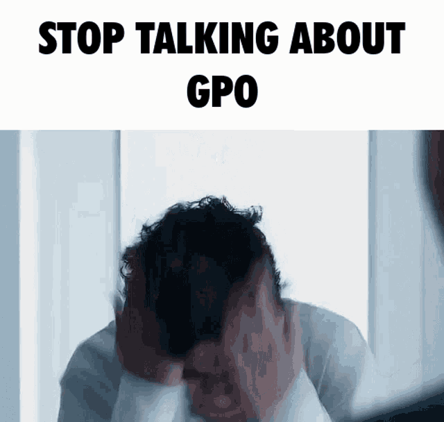 a man is covering his face with his hands and the words stop talking about gpo are above him .