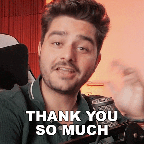 a man in front of a microphone with the words thank you so much on his face