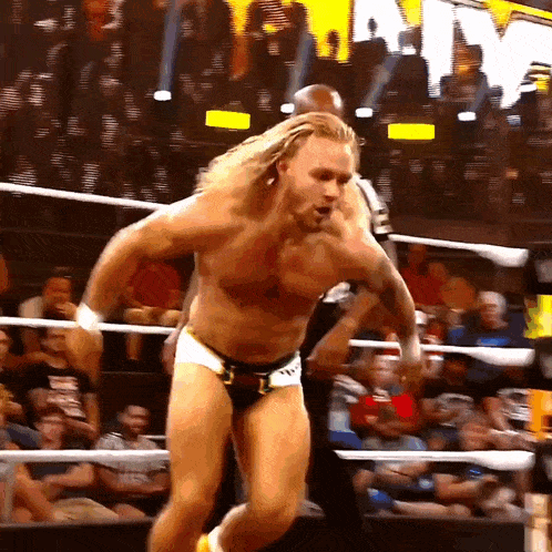 a man in a wrestling ring with a crowd behind him and the word army behind him