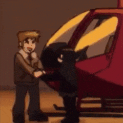 a man is standing next to a red helicopter and shaking hands .