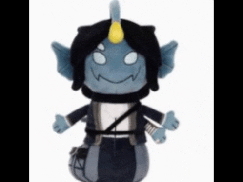 a stuffed toy that looks like a monster with a horn on its head