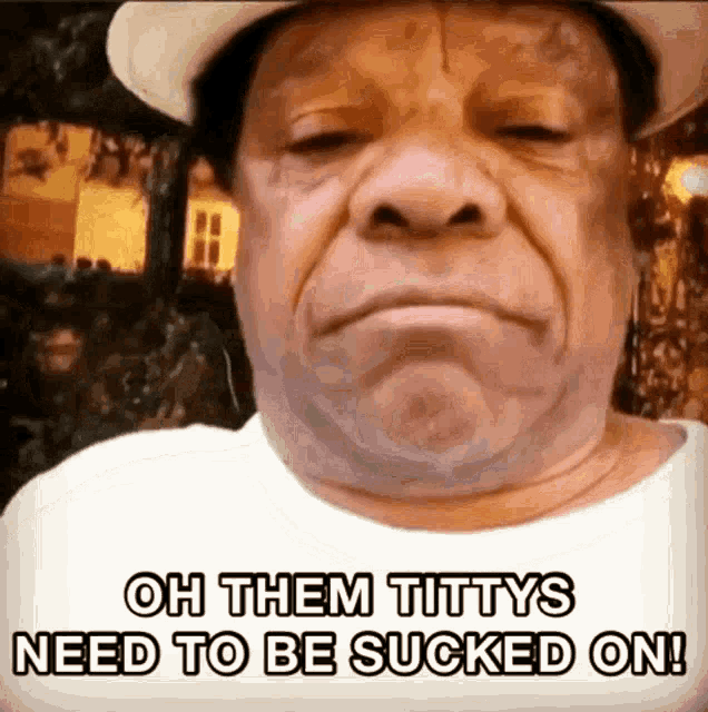 a man wearing a cowboy hat and a white shirt says oh them tittys need to be sucked on