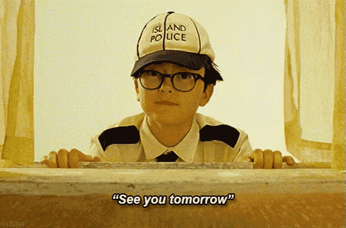 a boy wearing an island police hat and glasses says see you tomorrow