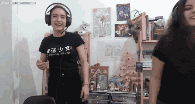 a girl wearing headphones and a black shirt that says magical girl