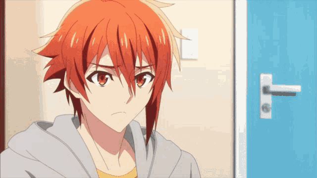 a boy with red hair and red eyes stands in front of a blue door