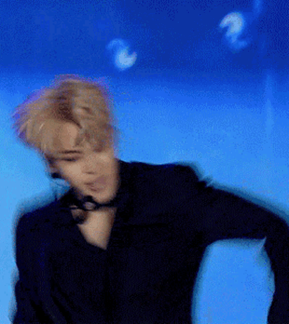 a blurry picture of a man with a microphone on his neck