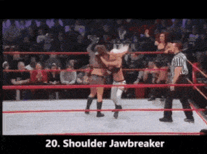 two women are wrestling in a wrestling ring with a referee watching .