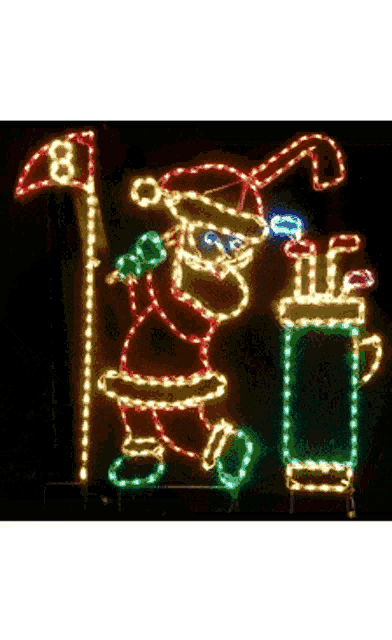 a christmas lights display of santa holding a golf club