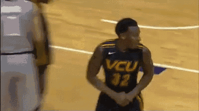 a basketball player wearing a jersey that says vcu on it
