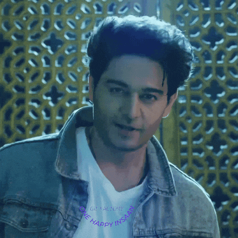 a man wearing a denim jacket and a white shirt that says the happy inside