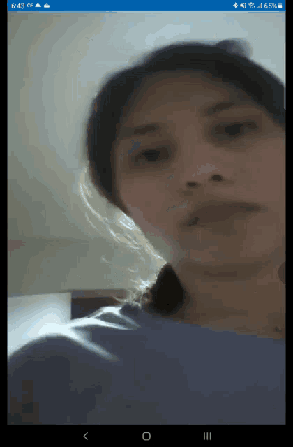 a screenshot of a woman 's face on a phone screen