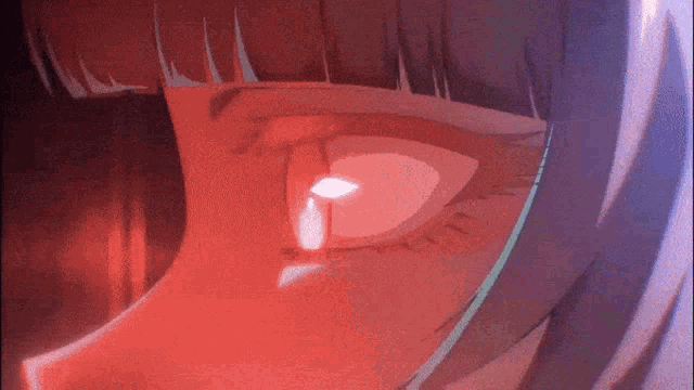 a close up of a woman 's eye with a red light coming out of it