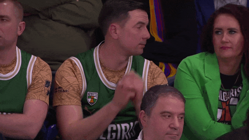 a man wearing a green and gold jersey that says lgiris