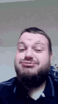 a man with a beard has his eyes closed and his mouth open