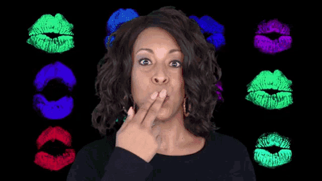 a woman with a surprised look on her face is surrounded by colorful lips prints