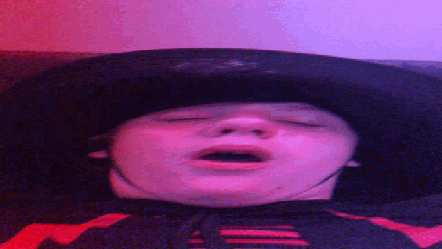 a person with their mouth open is wearing a black and red shirt