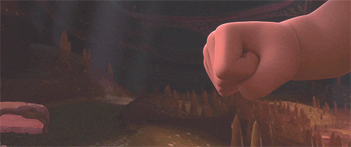 a cartoon character 's fist is being thrown in a dark room