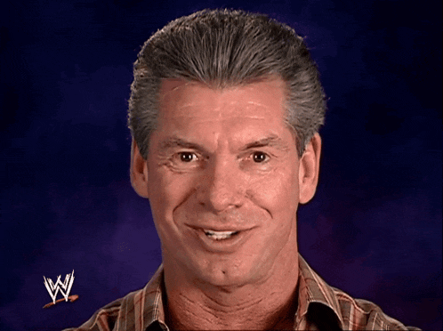 a man with a wrestling logo on his shirt