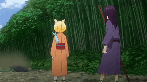 a group of people standing in front of a bamboo forest with one of them holding a sword
