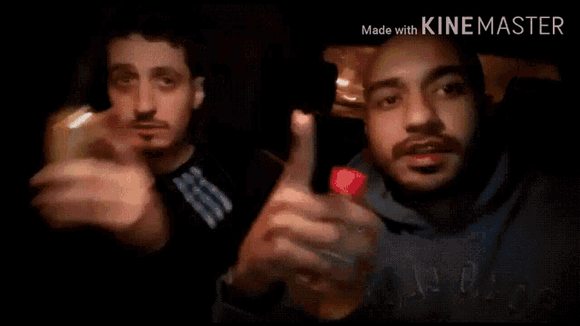a man is holding a bag of doritos while another man watches