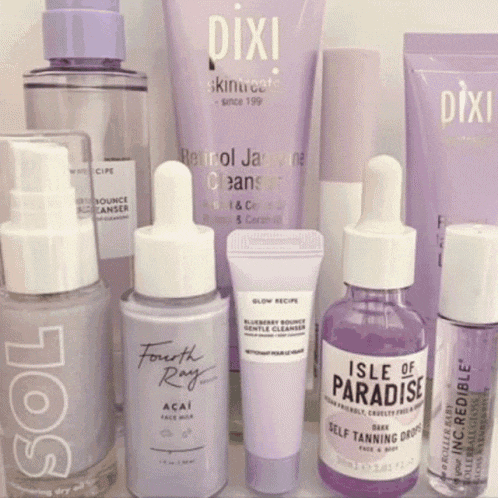 a bottle of isle of paradise self tanning drops sits next to other bottles