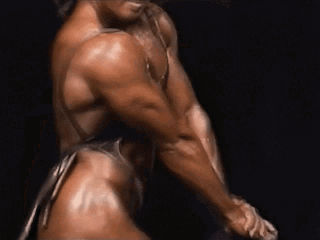 a muscular man in a thong is flexing his muscles