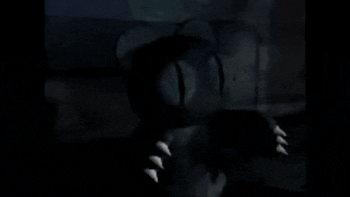 a cartoon character is standing in the dark with sharp claws on his feet .