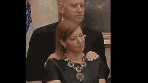 a man and a woman are sitting next to each other .