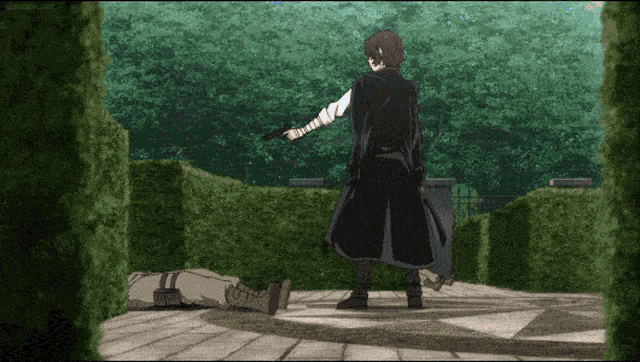 a man in a black coat is standing in front of a statue