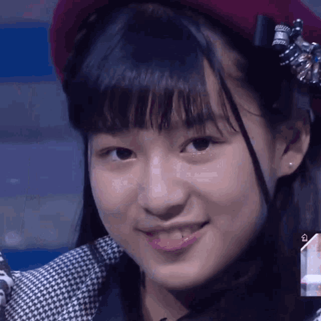 a close up of a girl 's face with a hat on