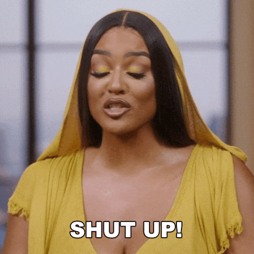 a woman in a yellow dress is saying " shut up "