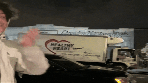 a man in front of a healthy heart truck