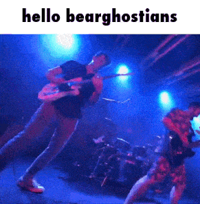 a man playing a guitar on a stage with the words hello bearghostians below him