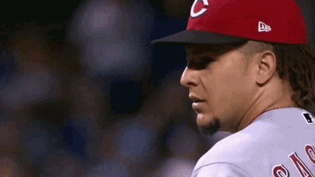 a man wearing a red hat with a c on it