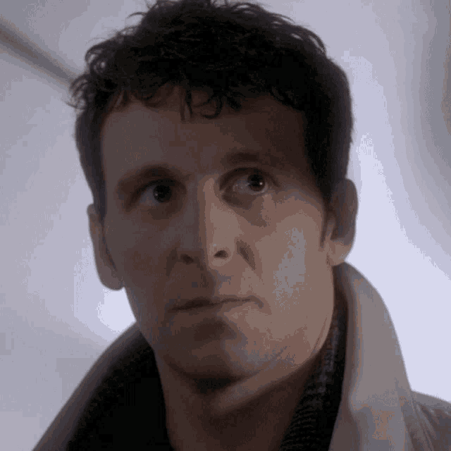 a close up of a man 's face with a serious expression