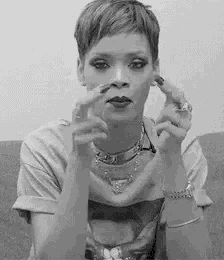 a black and white photo of a woman with short hair making a funny face