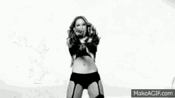 a black and white photo of a woman dancing in lingerie .