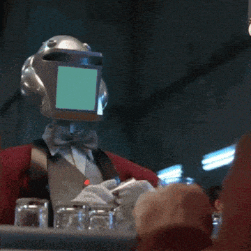 a robot with a green screen on his head is holding a bottle